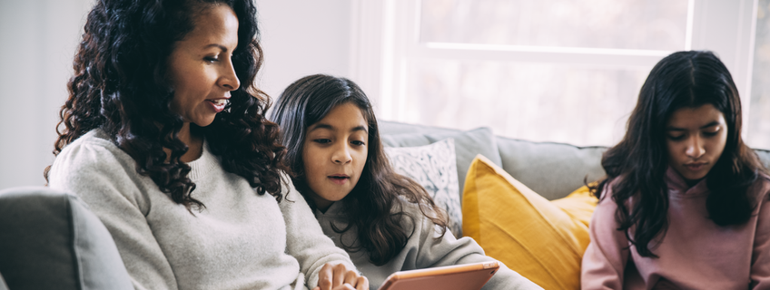Mother and daughters relaxing together at home